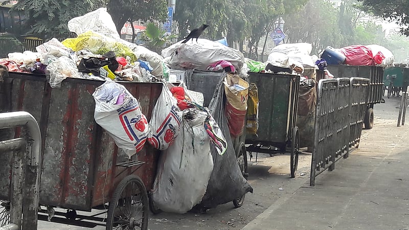 Lines of garbage collecting three-wheelers outside a Dhaka landfill site.