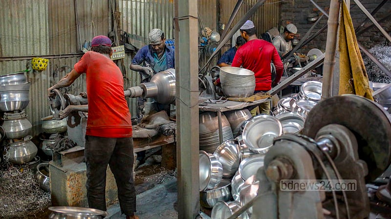 Workers at an aluminium factory in Kamrangirchar are busy making utensils on Friday, May 26, 2023. Photo: Tawhiduzzaman Tapu