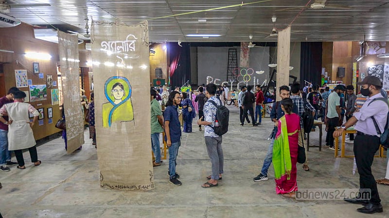 Visitors take a tour of an exhibition organised by the Titumir Art Club at the Shaheed Barkat Auditorium on Monday, May 29, 2023. Photo: Tawhiduzzaman Tapu