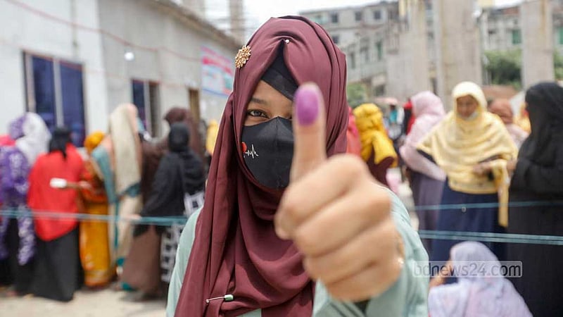 Halima Akter, a student, shows ink on the thumb after casting her vote at the Madrasatul Islam Tongi and Shamsunnahar Mohila Madrasa centre during the Gazipur City Corporation election on Thursday, May 25, 2023. Photo: Mahmud Zaman Ovi