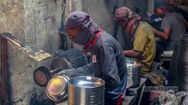 Workers polish utensils manufactured in a factory in Kamrangirchar. Photo taken on Friday, May 26, 2023. Photo: Tawhiduzzaman Tapu