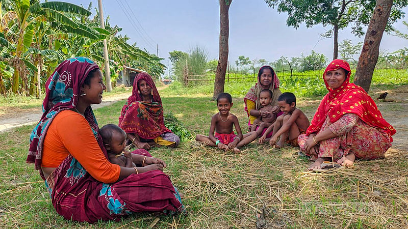 Mothers take a break from their work to sit with their children. Such tranquil scenes can be witnessed at a Padma River island in Natore’s Lalpur. Photo: Tariqul Hasan