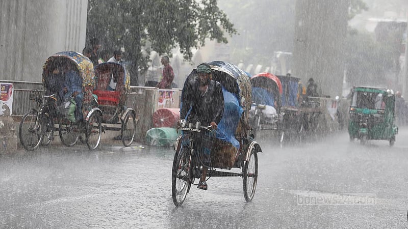 A rickshaw-puller pedals his three-wheeler through rains at Paltan in Dhaka after days of scorching heat on Saturday, May 6, 2023. Photo: Asif Mahmud Ove