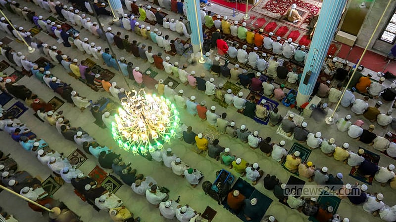 Muslims take part in Eid prayers at Baitul Mukarram National Mosque as the rain pours down on Thursday, Jun 29, 2023. Photo: Asif Mahmud Ove