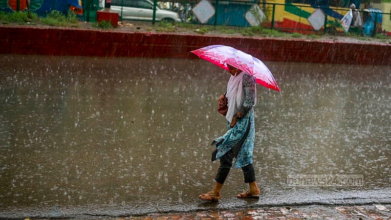 A woman walks holding an umbrella amid rains in Dhaka’s Mohammadpur on Friday, Jun 9, 2023. Photo: Tawhiduzzaman Tapu