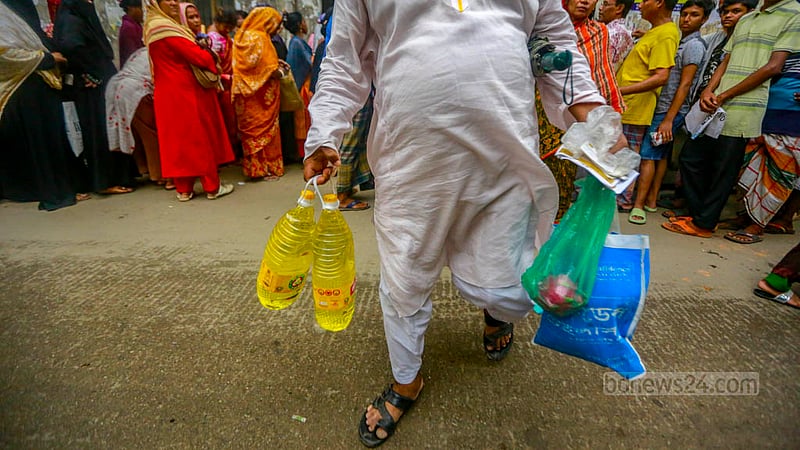 Customers stand in front of a TCB dealer’s shop after buying essentials in Dhaka’s Lalbagh on Sunday, Jun 11, 2023. Photo: Tawhiduzzaman Tapu