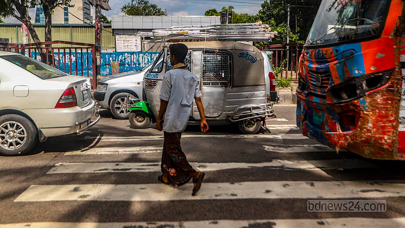 Vehicles parked on a zebra crossing at the Tejgaon signal cause inconvenience to pedestrians.
