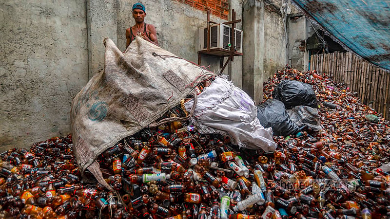 A worker sorts bottles from sacks at a plastic waste recycling factory in Dhaka’s Hazaribagh. Photo: Tawhiduzzaman Tapu