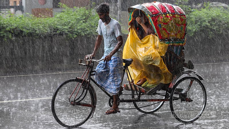 A rickshaw driver struggles through the rain to take his passengers to their destination in Dhaka’s Mirpur on Wednesday, Jun 26, 2023. Photo: Asif Mahmud Ove