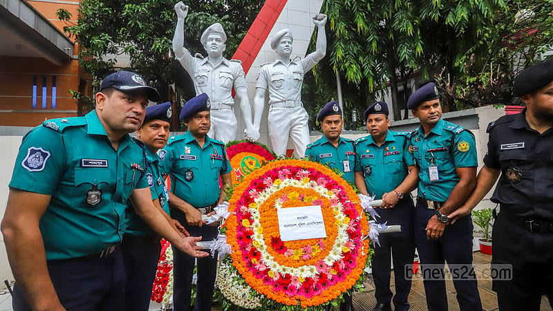 Colleagues pay their respects to the victims of the Holey Artisan terrorist attack at the mural of two slain police officers on the 7th anniversary of the tragedy on Saturday, Jul 1, 2023. Photo: Asif Mahmud Ove