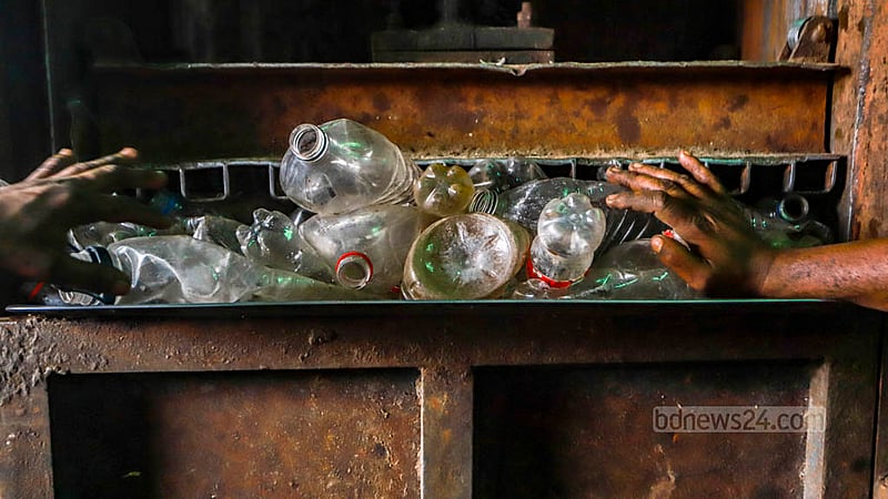 Plastic bottles are being processed by machines based on their colour groups. Photo: Tawhiduzzaman Tapu