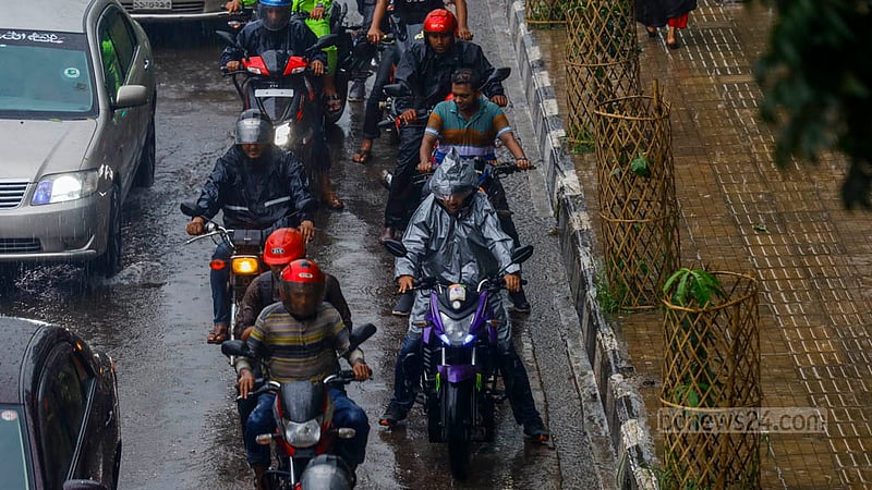 Motorcyclists wearing raincoats drive through rain in Dhaka’s Tejgaon on Thursday, Aug 10, 2023. Photo: Mahmud Zaman Ovi