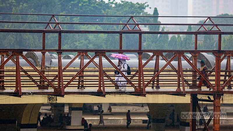 Students carry colourful umbrellas on their way home from school in the rain. Photo: Mahmud Zaman Ovi