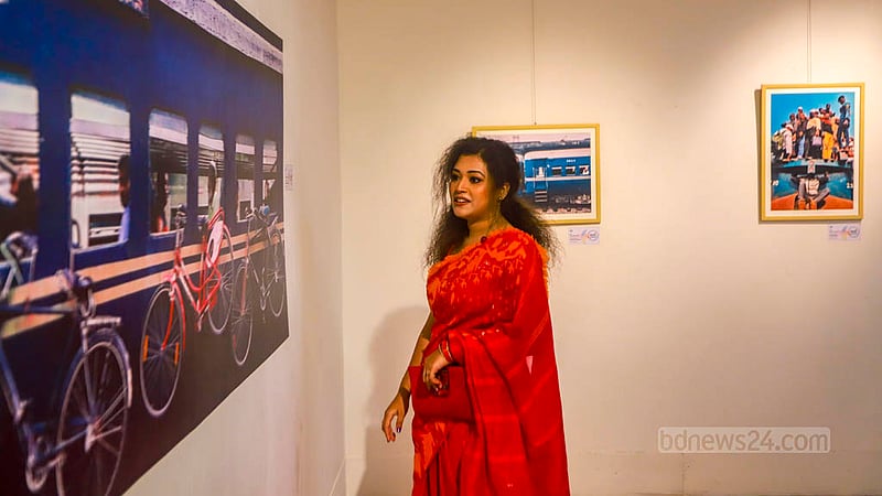 A woman looks at a photo taken with a mobile phone at a photography exhibition of Bhromon Konya - The Travelettes of Bangladesh, a group of women who love to travel, at the Shilpakala Academy in Dhaka on Saturday, Aug 5, 2023. Photo: Tawhiduzzaman Tapu