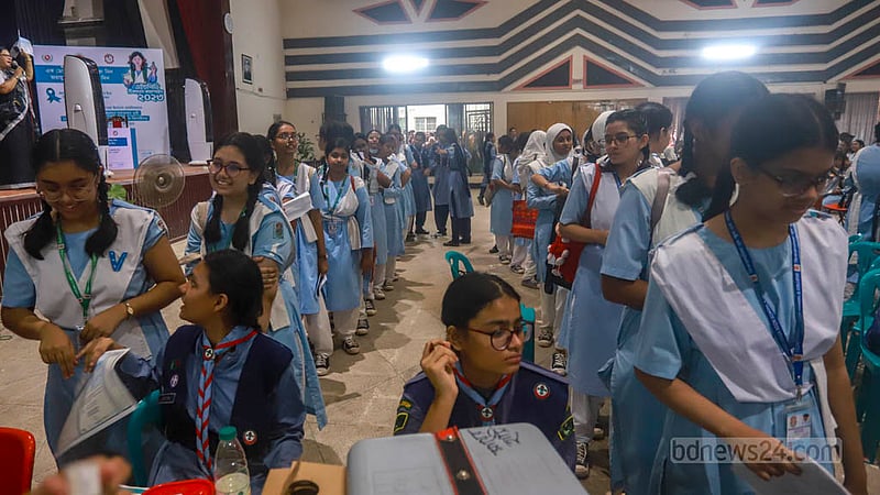 Students queue in a hallroom at Viqarunnisa Noon School and College to receive a vaccine to combat cervical cancer on Sunday, Oct 15, 2023. Photo: Tawhiduzzaman Tapu