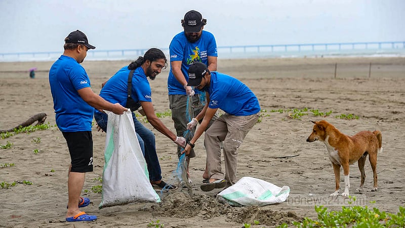 Volunteers from Dhaka clean up plastic and other garbage left by tourists at Cox's Bazar beach on Friday, Nov 17, 2023.