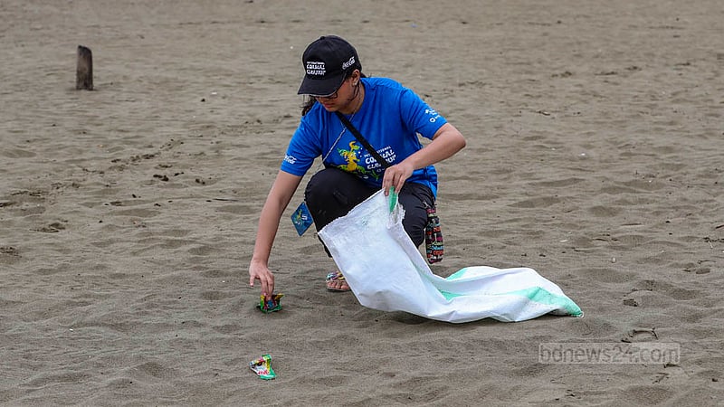 A volunteer participates in a Cox's Bazar beach cleaning campaign on Friday, Nov 17, 2023.
