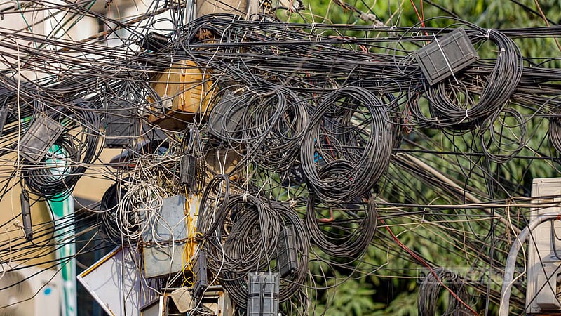 The internet and cable TV wires dangling from electrical poles sometimes short circuit and go up in flames. Photo: Mahmud Zaman Ovi