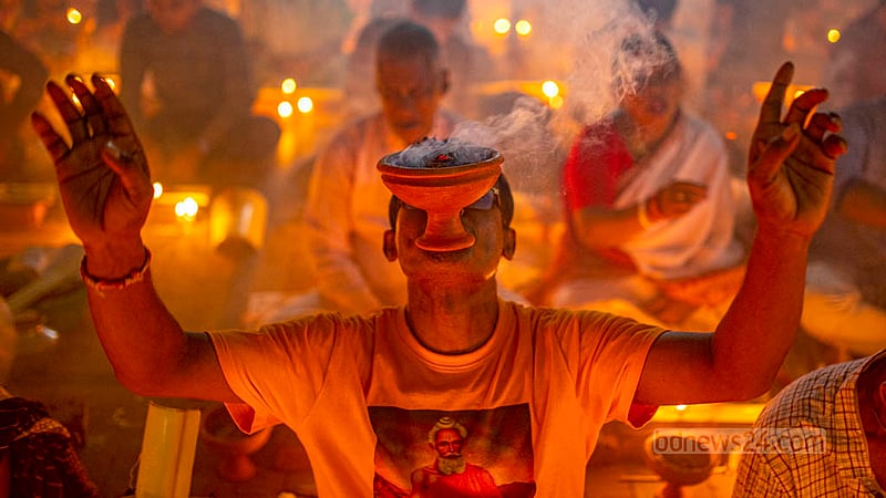 A disciple of Baba Lokenath Brahmachari prays during Rakher Upobash or Kartik Broto festival at Barodi Lokenath Ashram in Narayanganj on Saturday, Nov 11, 2023.