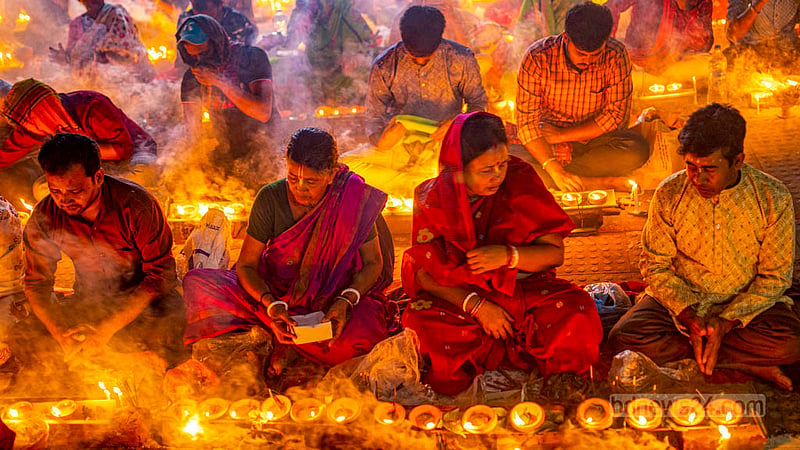Disciples of Baba Lokenath Brahmachari pray during Rakher Upobash or Kartik Broto festival at Barodi Lokenath Ashram in Narayanganj on Saturday, Nov 11, 2023.