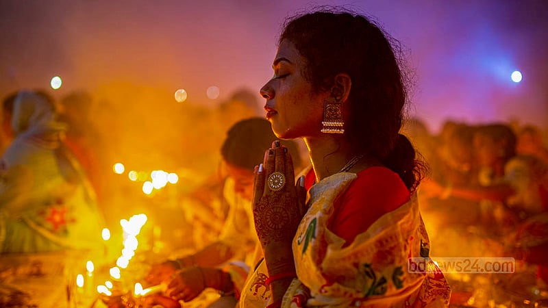 A disciple of Baba Lokenath Brahmachari prays during Rakher Upobash or Kartik Broto festival at Barodi Lokenath Ashram in Narayanganj on Saturday, Nov 11, 2023.