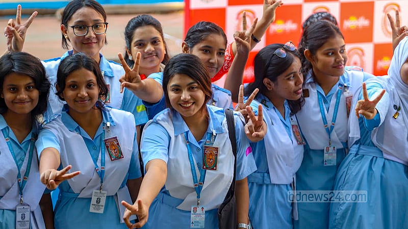 Viqarunnisa Noon School and College students flash the victory sign in joy after the publication of the results of HSC exams on Sunday, Nov 26, 2023.