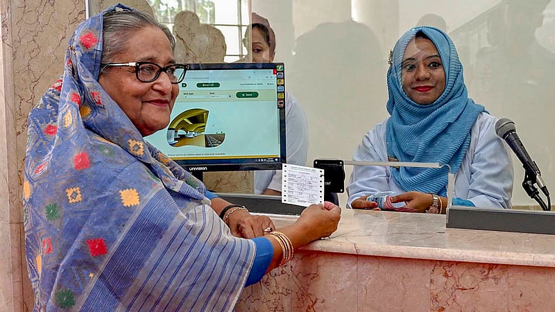 Prime Minister Sheikh Hasina buys a ticket for a train trip to Ramu after the inauguration of the first rail link to Cox’s Bazar on Saturday, Nov 11, 2023.