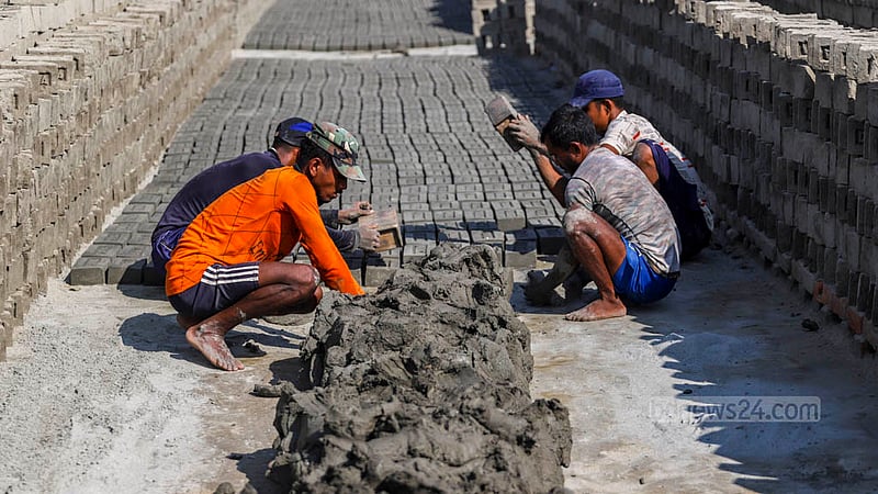 Workers from Mymensingh are moulding clay into raw bricks at a kiln near the Buriganga River in Dhaka’s Basila. Photo: Tawhiduzzaman Tapu