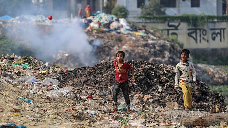 Children are playing next to a pile of burning plastics without protection from the toxic fumes, risking their health.