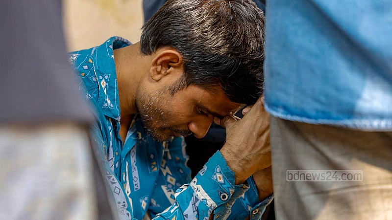 Husband Mizanur Rahman waits outside the morgue of Dhaka Medical College Hospital to receive the bodies of Nadira Akter Poppy and their son Yasin, victims of the Mohanganj Express train fire.