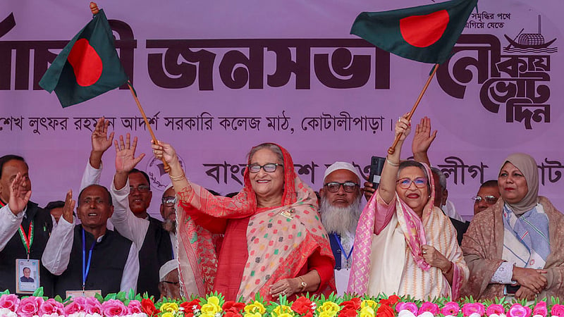Prime Minister Sheikh Hasina and her sister Sheikh Rehana wave the flag of Bangladesh at an electoral rally at Government Sheikh Mujibur Rahman College grounds in Gopalganj’s Tungipara.