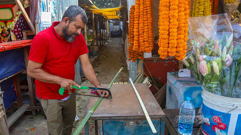A floral designer is all tied up arranging colourful wreaths ahead of Victory Day in Dhaka's Agargaon.