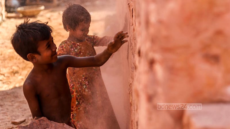 Children play in a brick kiln near the Buriganga River in Dhaka’s Basila, where their mother works. Photo: Tawhiduzzaman Tapu