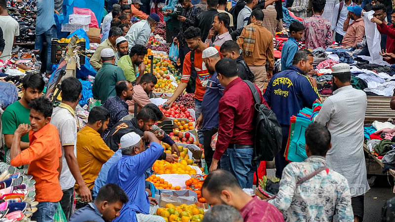 Some hawkers sell clothes and shoes on the road in Dhaka's Gulistan, while others sell fruit.