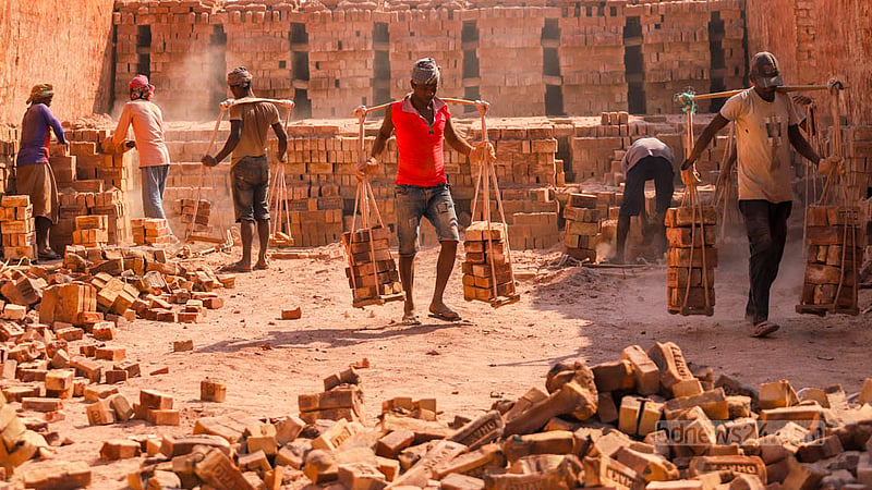 Workers are moving bricks in a kiln on the bank of the Buriganga River at Basila in Dhaka. Photo: Tawhiduzzaman Tapu