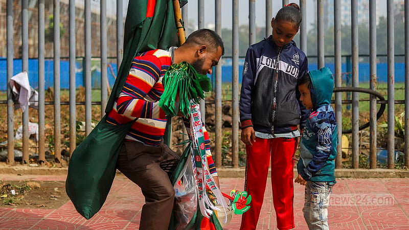 Children buy the Bangladesh national flag from a vendor in Dhaka's Dhanmondi.