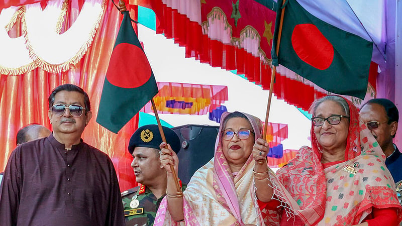 Prime Minister Sheikh Hasina and her sister Sheikh Rehana wave the flag of Bangladesh greeting the people at an electoral rally at Sheikh Lutfar Rahman Adarsha Government College grounds in Gopalganj’s Kotalipara.