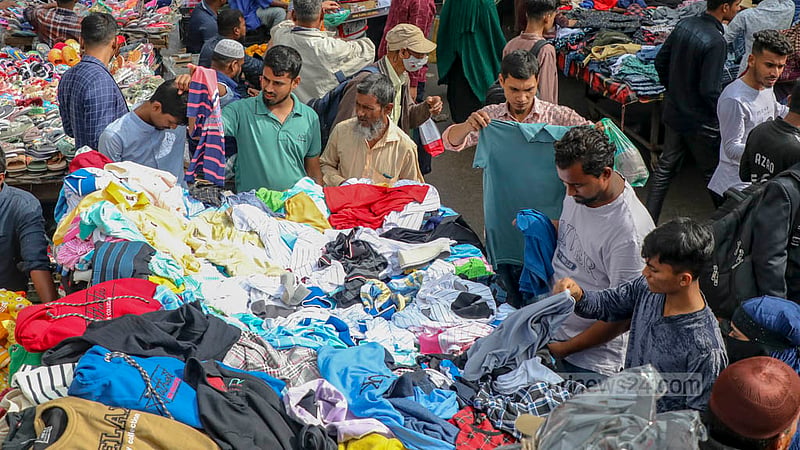 Hawkers sit on the road in Dhaka's Gulistan with makeshift shops selling winter clothes.