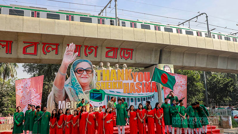 Students make various arrangements to greet Prime Minister Sheikh Hasina prior to the inauguration of the metro rail station at Dhaka University. They performed a patriotic song in front of the Raju Memorial Sculpture as part of the rally.   Photo: Mahmud Zaman Ovi