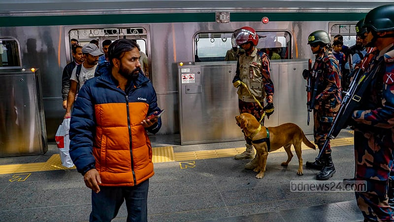 BGB personnel watch passengers at Agargaon Metro Rail Station in Dhaka on Sunday, Dec 31, 2023, ahead of the Jan 7 general election.
