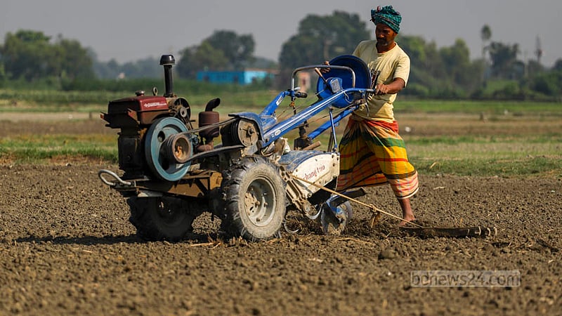 A farmer uses a power tiller to prepare the field to grow winter vegetables in Keraniganj’s Hazratpur. Photo: Tawhiduzzaman Tapu