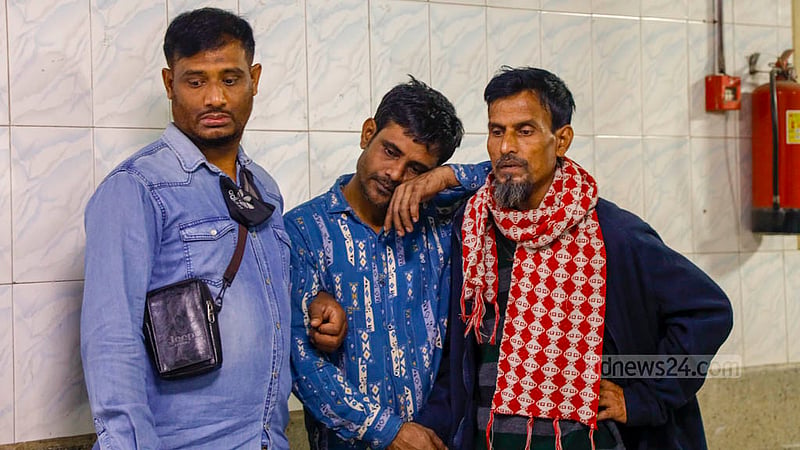 Husband Mizanur Rahman waits outside the morgue of Dhaka Medical College Hospital to receive the bodies of Nadira Akter Poppy and their son Yasin, victims of the Mohanganj Express train fire.