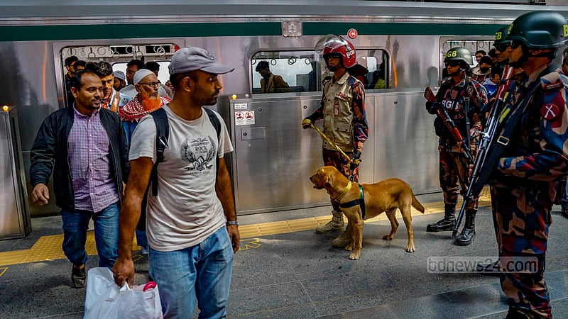 BGB personnel watch passengers at Agargaon Metro Rail Station in Dhaka on Sunday, Dec 31, 2023, ahead of the Jan 7 general election.