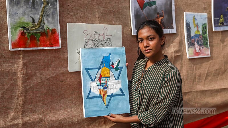 Soma Aleen, a fine arts student of Jahangirnagar University, shows her pro-Paletinian paintings in an exhibition in the TSC area of Dhaka University on Tuesday afternoon, Dec 12, 2023.