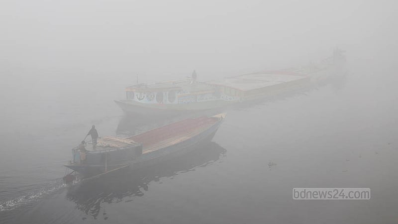 Boats move through a thick layer of fog on the Buriganga River on Wednesday morning, Jan 24, 2024.