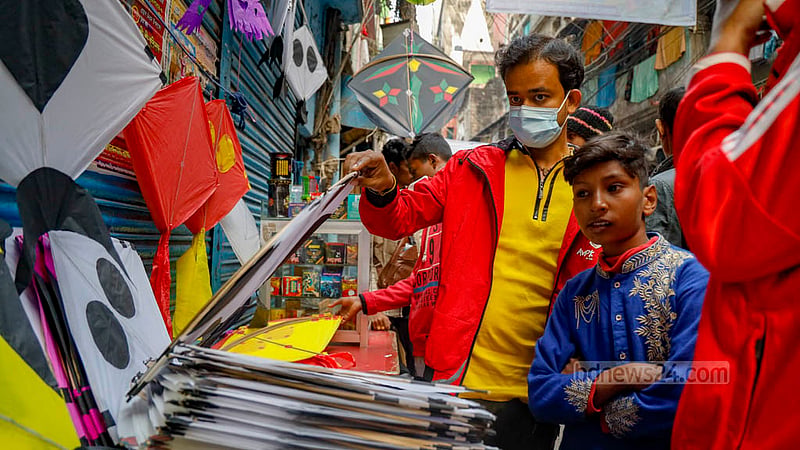 A buyer is absorbing the bright hues of the kites displayed at Shankharibazar. The shopkeepers also sell kites made of polythenes, besides the usual paper-made ones.
