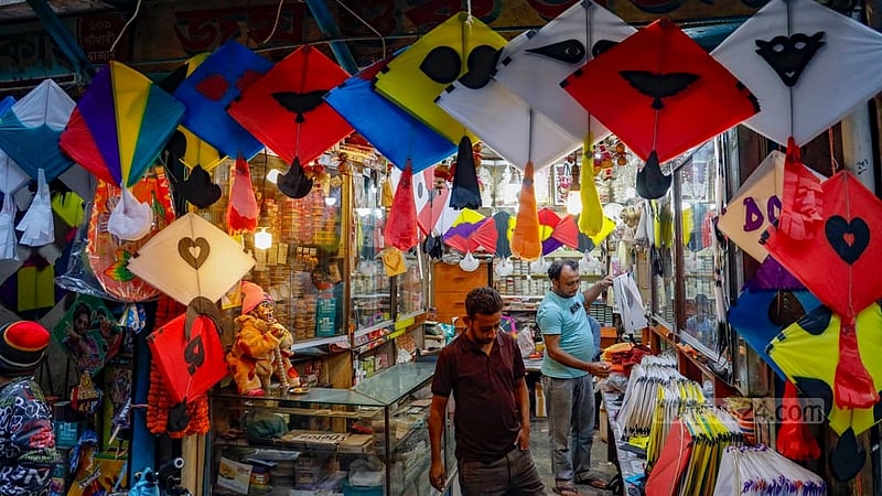 A shopkeeper is arranging the kites in his shop at Shankharibazar. The price of paper kites, which once used to be Tk 5, is now being sold at Tk 10. Elaborate designs on the colourful papers are costlier, ranging from Tk 15 to Tk 25.