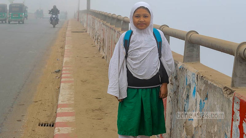 Saima, a third-grade student who gave a single name, is heading to school one hour later than the schedule in Dhaka's Bosila amidst dense fog on Wednesday morning, Jan 24, 2024.