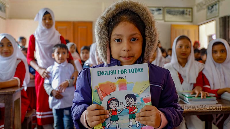 Wafiya Khanam Karbi, a first-grader at Raydakkhin Government Primary School in Manikganj’s Singair Upazila, shows off her new textbooks.