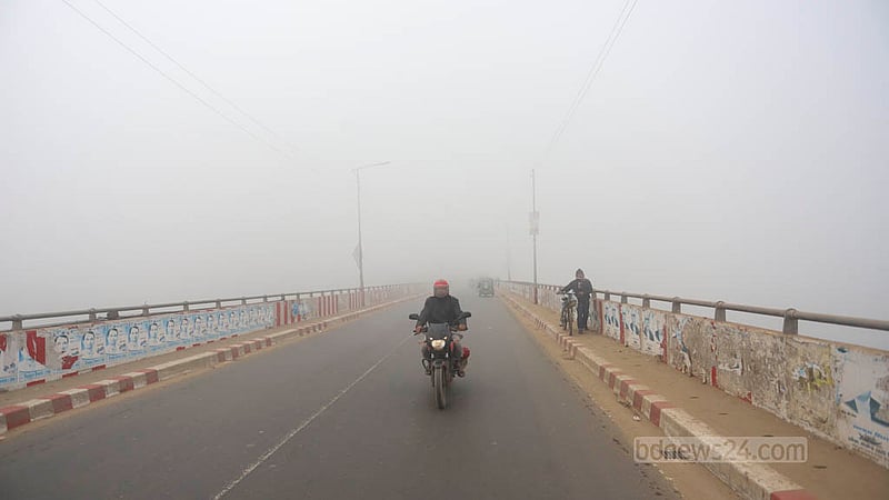 Fog covers the Bosila Bridge area of Dhaka early in the morning on Wednesday, Jan 24, 2024.